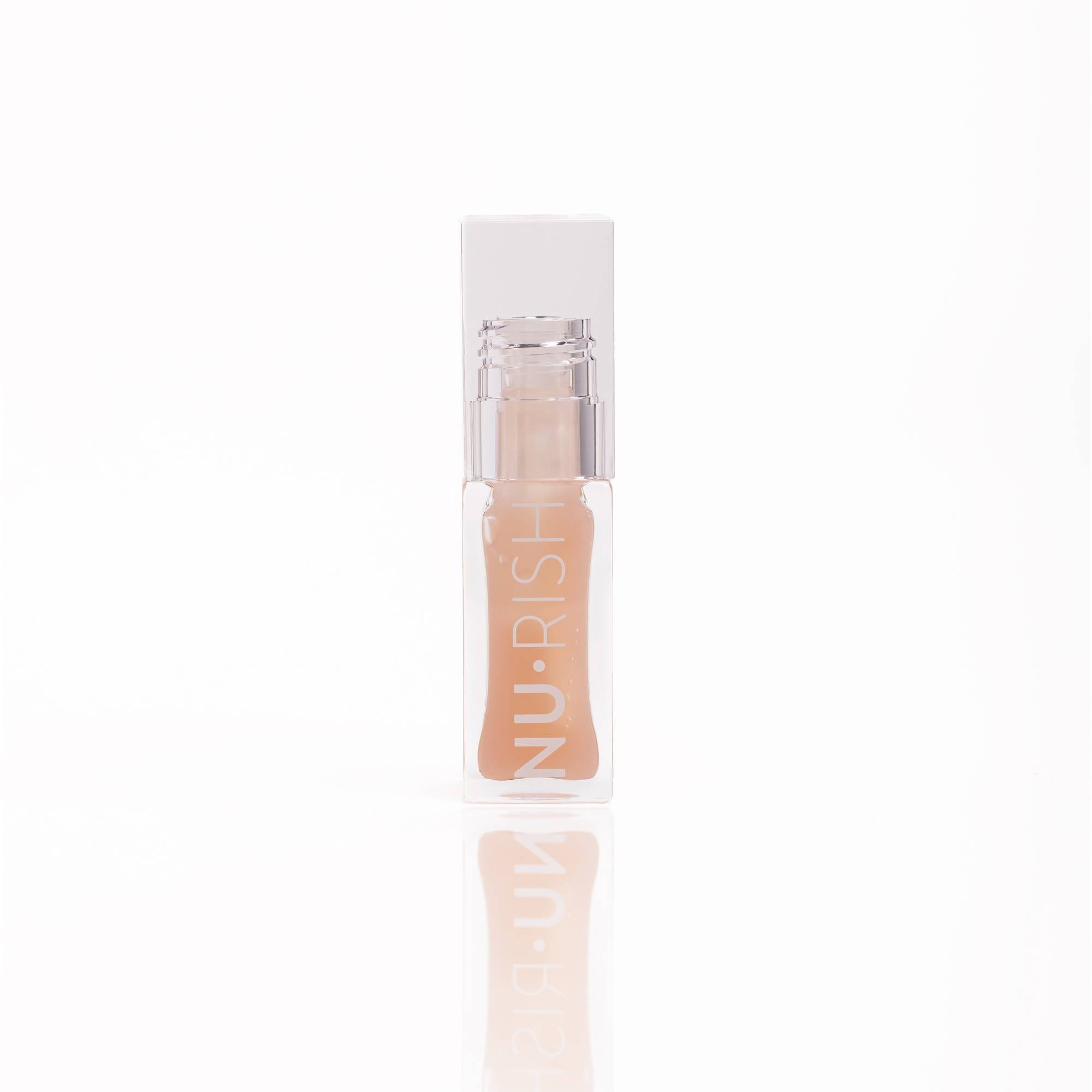 Huile à lèvres NU•RISH bioactive en flacon transparent, soin hydratant et repulpant pour des lèvres lisses, brillantes et confortables. NU•RISH bioactive lip oil in a transparent bottle, a moisturizing and plumping treatment for smooth, shiny, and comfortable lips.